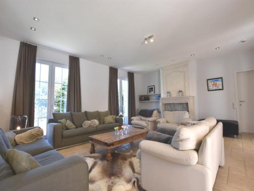 a large living room with couches and a table at Luxury Villa in Sint-Idesbald with Jacuzzi in Sint-Idesbald