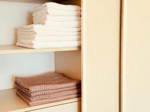 a stack of towels on a shelf in a closet at Hillside Apartment with Sea View in Budva
