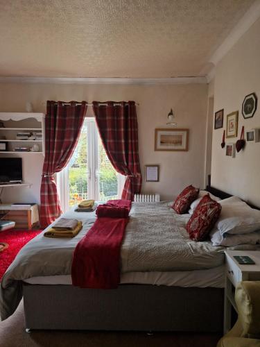 a bedroom with a large bed with a window at Littlebeck in Danby
