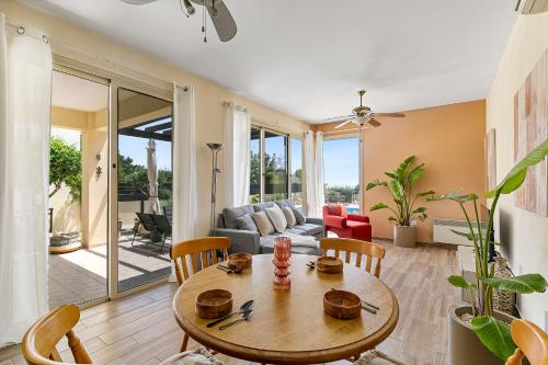 a living room with a table and chairs at Seaview Villa in Peyia | Private pool & jacuzzi by VICHY Holidays in Paphos