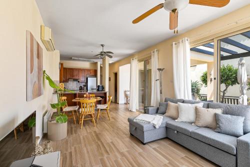 a living room with a couch and a table at Seaview Villa in Peyia | Private pool & jacuzzi by VICHY Holidays in Paphos