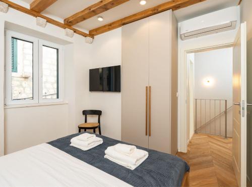 a bedroom with a bed with towels on it at Villa Jele in Dubrovnik