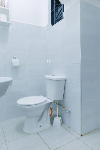 a bathroom with a toilet and a sink at Pearl Homes Nanyuki in Nanyuki