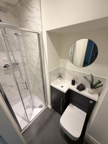 a bathroom with a shower and a toilet and a sink at 4 James street in Selby