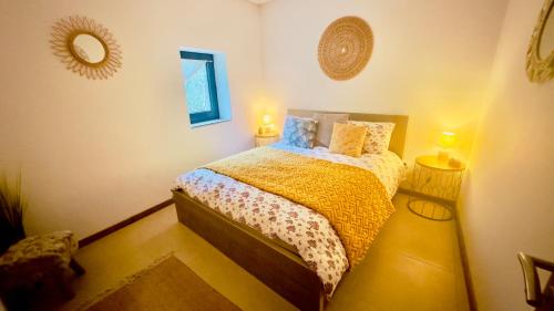 a bedroom with a bed with two lights on at Wylde Roots River House - with natural river swimming pools in Couto de Baixo