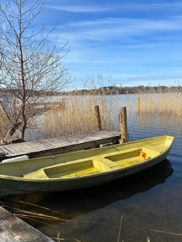 a yellow boat sitting next to a dock at Sun Slottet in Stockholm