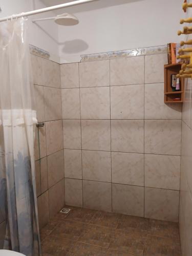 a shower with a shower curtain in a bathroom at Quarto Privativo e Camping em Canoa Quebrada in Canoa Quebrada