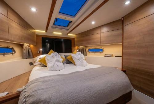 a bedroom with a large bed on a boat at 2BR Heated Yacht, Lymington Centre, Beautiful View in Lymington
