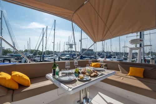 a table with food and drinks on a balcony on a boat at 2BR Heated Yacht, Lymington Centre, Beautiful View in Lymington