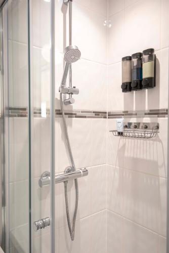 a shower in a bathroom with a glass door at The Burleigh palace in Cambridge