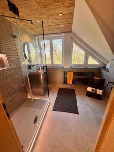 an overhead view of a bathroom with a shower at Design Dachgeschoss Wohnung in Eilenburg