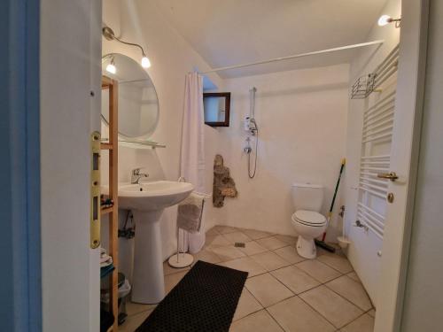 a white bathroom with a sink and a toilet at Le Coccinelle in Pallerone