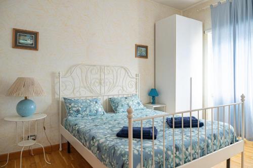 a bedroom with a white bed with blue pillows at AppleCat in Rome