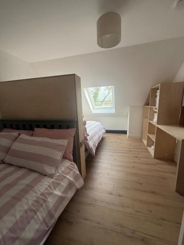 a bedroom with two beds and a window in it at Rosies Lodge in Kilkenny