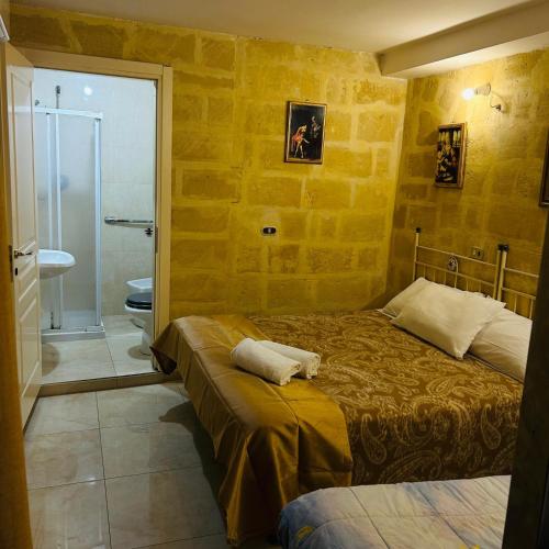 a bedroom with two beds and a bathroom with a shower at Santa Cesarea Sassi in Matera