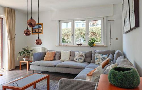 a living room with a couch and a table at Goudstrand in Oostduinkerke