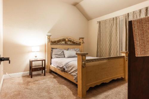 a bedroom with a bed with a wooden frame at Osile Villa in DeSoto