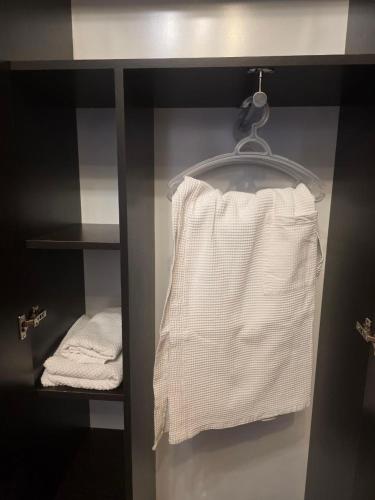 a closet with some towels on a shelf at House 56 in Yerevan