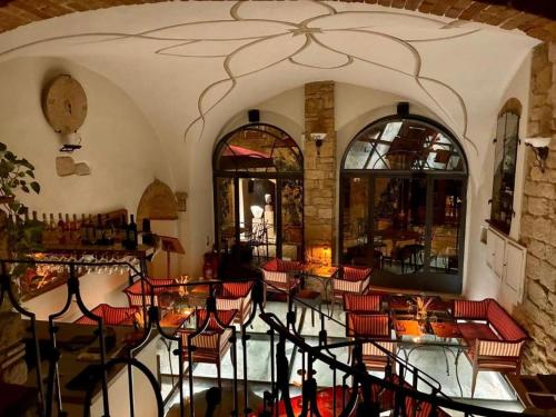 a room with chairs and tables in a building at Casa Falconcini in Volterra