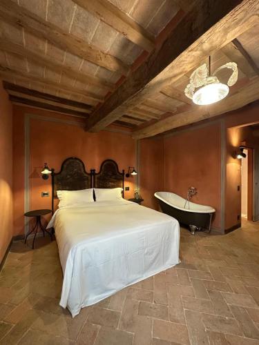 a bedroom with a large bed and a bath tub at Casa Tarabuso B&B in Reggio Emilia