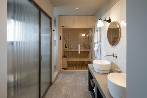 a bathroom with a shower and a sink and a mirror at Vigne del Malina - Agriturismo & Winery in Orzano