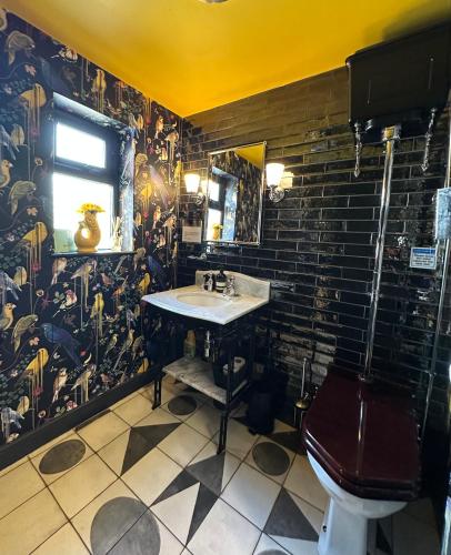 a bathroom with a sink and a toilet at Comfortable Room or Whole House - 4BR 1BATH 1TOILET at Suffolk Pink House, Newmarket in Newmarket