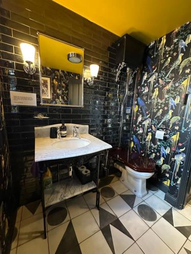 a bathroom with a sink and a toilet at Comfortable Room or Whole House - 4BR 1BATH 1TOILET at Suffolk Pink House, Newmarket in Newmarket