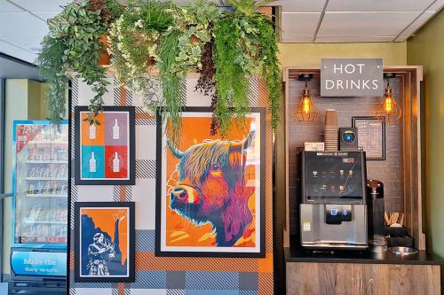 a store with a picture of a cow on the wall at easyHotel Glasgow City in Glasgow