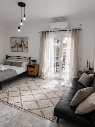 a bedroom with a bed and a couch at Olive tree Apartment Kanoni in Kanoni