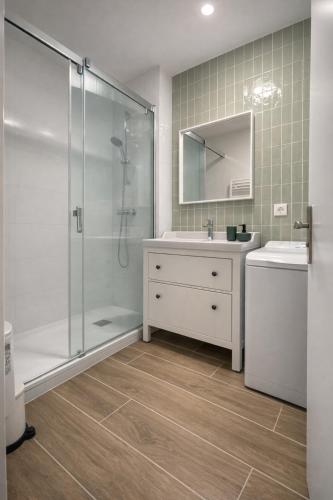 a bathroom with a shower and a sink and a mirror at La Cachette du Lac-Douce parenthèse en famille près du lac & piscine in Lacanau