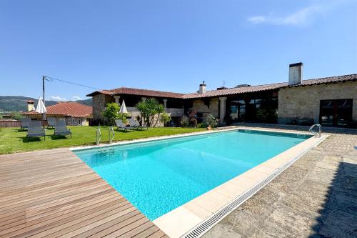 a swimming pool in front of a house at Hotel Rural Alves - BRAGA - Casa Alves de Torneiros in Braga