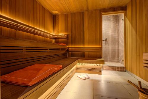 a sauna with a bench and a shower in it at Villa MONTGOMMERY in Saint-Jean-le-Thomas