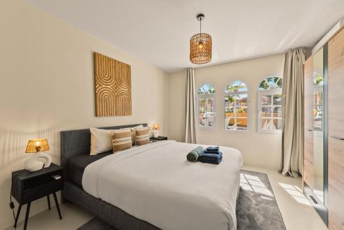a bedroom with a large bed and two windows at Marina Apartment A2, luxury waterfront apartment Spanish Water, Jan Thiel, Curaçao in Jan Thiel