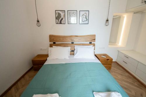 a bedroom with a large bed with a blue blanket at Agnanti in Agia Fotini