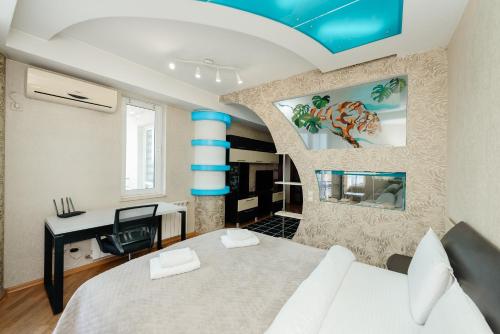 a bedroom with a bed and a desk in a room at ERA RENT Apartments in Chişinău