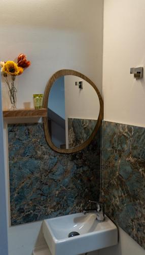 a bathroom with a sink and a mirror at Olympus Pool Retreat in Katerini