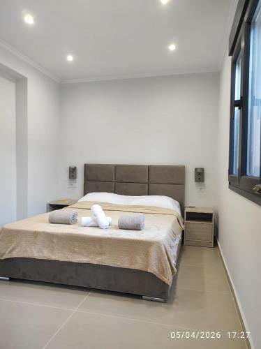 a bedroom with a bed with two towels on it at Calm Horizon Residence in Chios