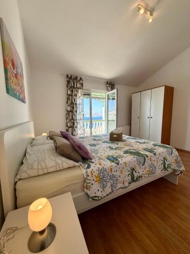 a bedroom with a large bed and a window at Holiday Home Larma in Senj