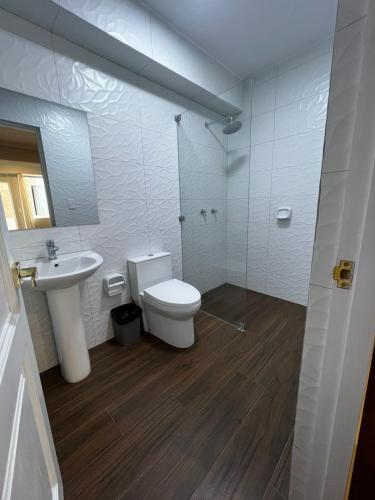 a bathroom with a toilet and a sink at Hotel Atenas in Barranco