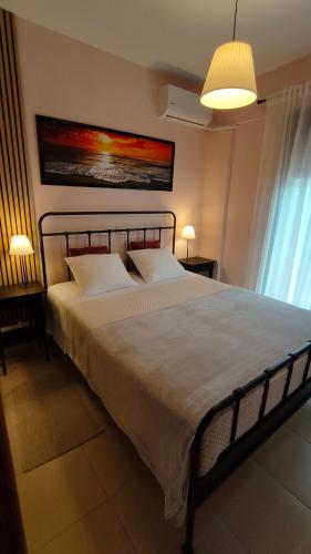 a bedroom with a large white bed in a room at SiviriLovelyApartment in Siviri