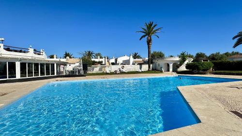 a large swimming pool in front of a house at Golfe - Shared Pool - 7 Pax - Vilamoura in Vilamoura