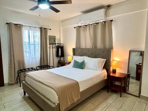 a bedroom with a bed and a ceiling fan at Stylish Apartments - FREE Bikes, Nice Area & Cozy Patio, 10 Minutes to Airport in Belize City