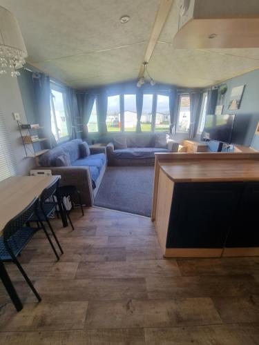 a living room with a couch and a table at 3 bed 2 bath Static on parkdean morecambe in Morecambe