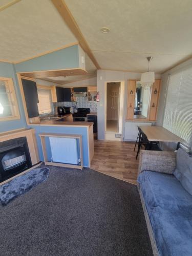 a large living room with a couch and a table at 3 bed 2 bath Static on parkdean morecambe in Morecambe
