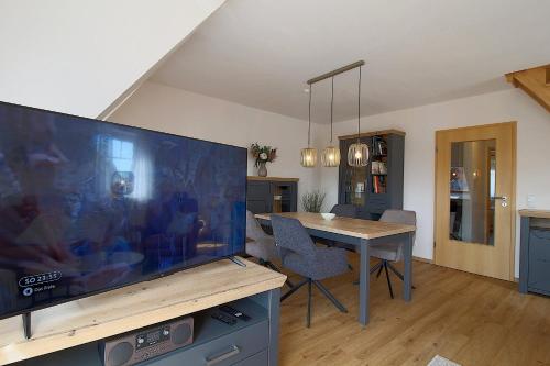 a living room with a large flat screen tv at PM09 KüstenReich in Wremen
