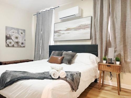 a bedroom with a bed with towels on it at The Cardinal Studio Apartments in Evansville