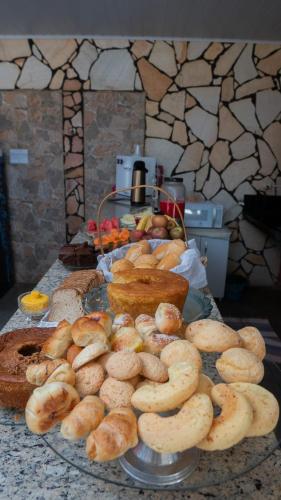 a plate of bread and pastries on a table at Hotel Oasis 2 in Conceição do Araguaia