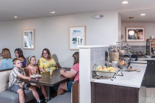 a group of people sitting at a table in a kitchen at Rockland Harbor Hotel in Rockland