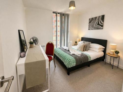 a bedroom with a bed and a desk in it at Apartment 3 in Birmingham