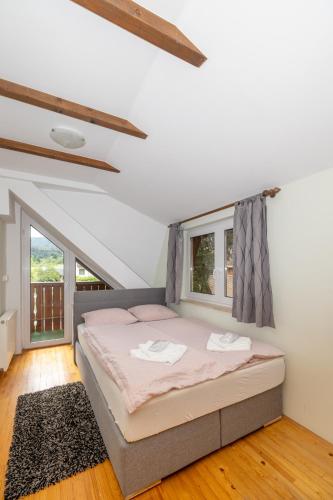 a bedroom with a bed and a large window at Rooms Hrominc in Bled